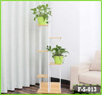 6-tier indoor flower rack display stand with green potted plants beside a sofa