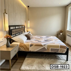 Modern bedroom with geometric-patterned bed, wooden headboard, bedside table and pendant lights