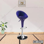 Modern blue bar stool with chrome base and footrest on wooden floor, perfect for home or office