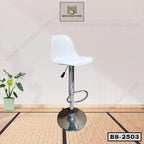 Modern white adjustable bar stool with chrome base and footrest on a minimal indoor floor.