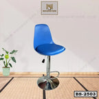Modern adjustable blue bar stool with chrome base and footrest on a textured floor