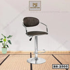 Modern adjustable bar stool with chrome base and dark fabric seat in a minimal indoor setting