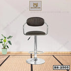 Modern adjustable bar stool with black cushioned seat and chrome base in a minimalist room