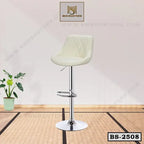 Modern adjustable bar stool with cushioned cream seat and chrome base on mat floor