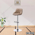 Modern beige bar stool with chrome base and footrest on a minimalist indoor setting