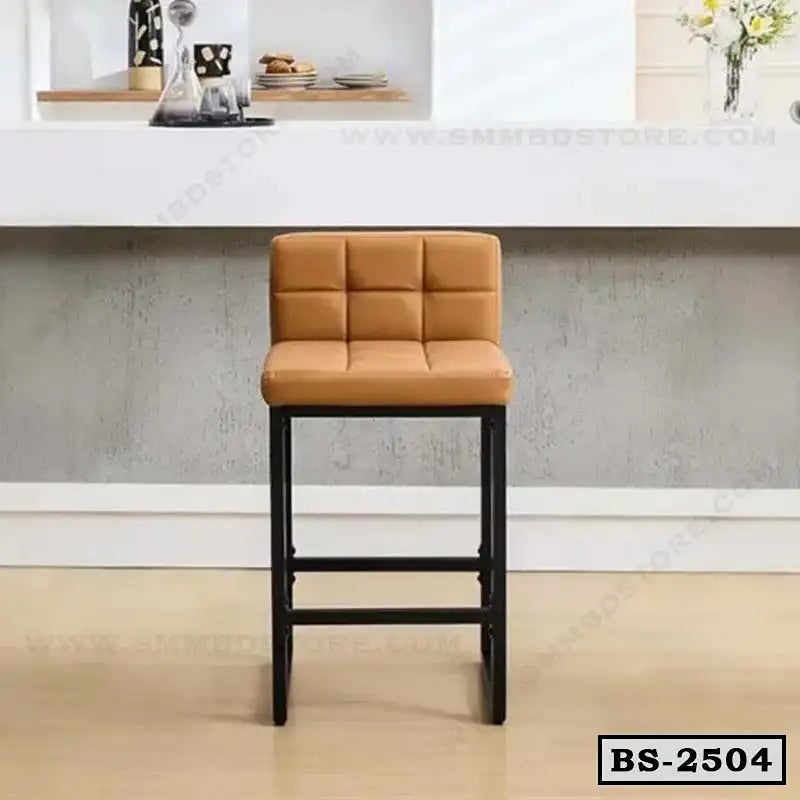 Modern bar stool with tan cushioned seat and black metal legs in a contemporary room