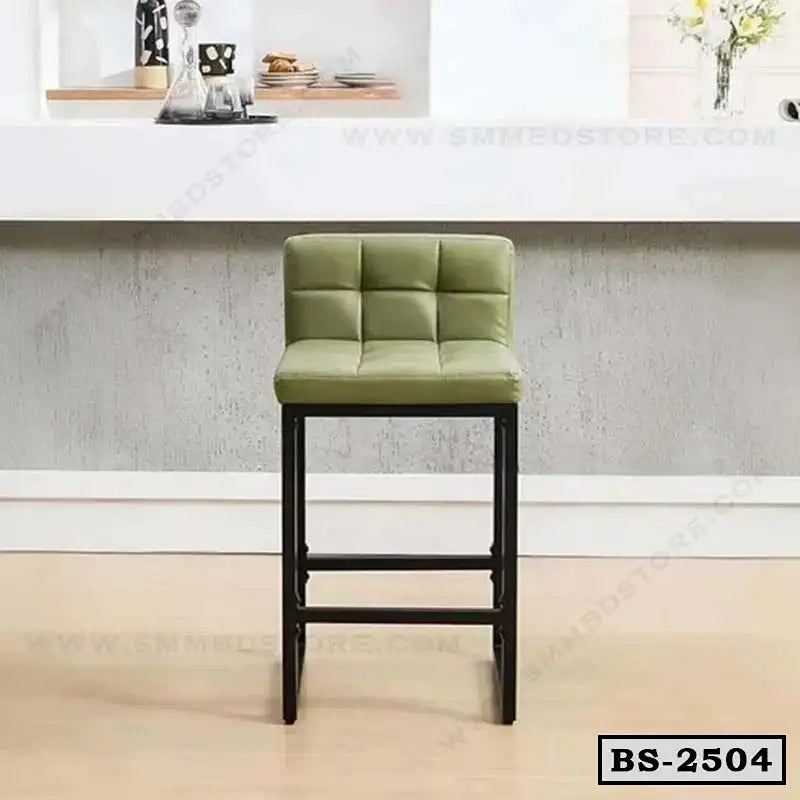 Modern green cushioned bar stool with black metal legs in a home interior setting