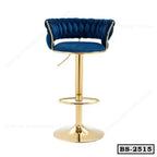 Blue velvet tufted bar stool with gold metal base and footrest, modern design.