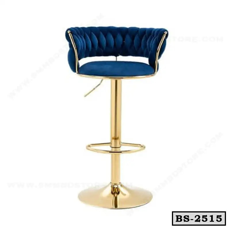 Blue velvet tufted bar stool with gold metal base and footrest, modern design.