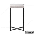 Modern bar stool with cushioned beige seat and black metal frame, minimalist design
