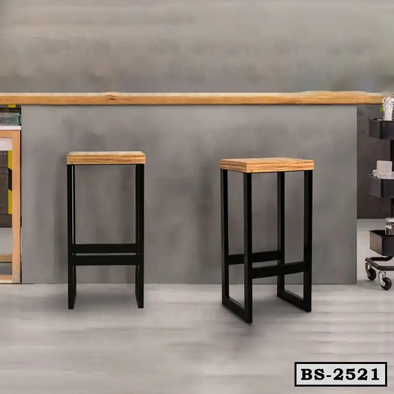 Modern bar stools with wooden seats and black metal legs in a minimalist room setting