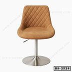 Modern tan bar stool with quilted backrest and chrome base, ideal for home or office