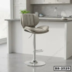 Modern beige bar stool with cushioned seat and chrome base in a kitchen setting