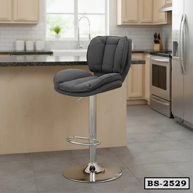 Modern gray padded bar stool with chrome base in a contemporary kitchen setting