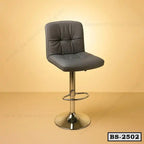 Modern adjustable bar stool with cushioned seat and chrome base on a beige background