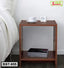 Modern wooden bedside table BST-955 with cup, clock and magazines next to a bed