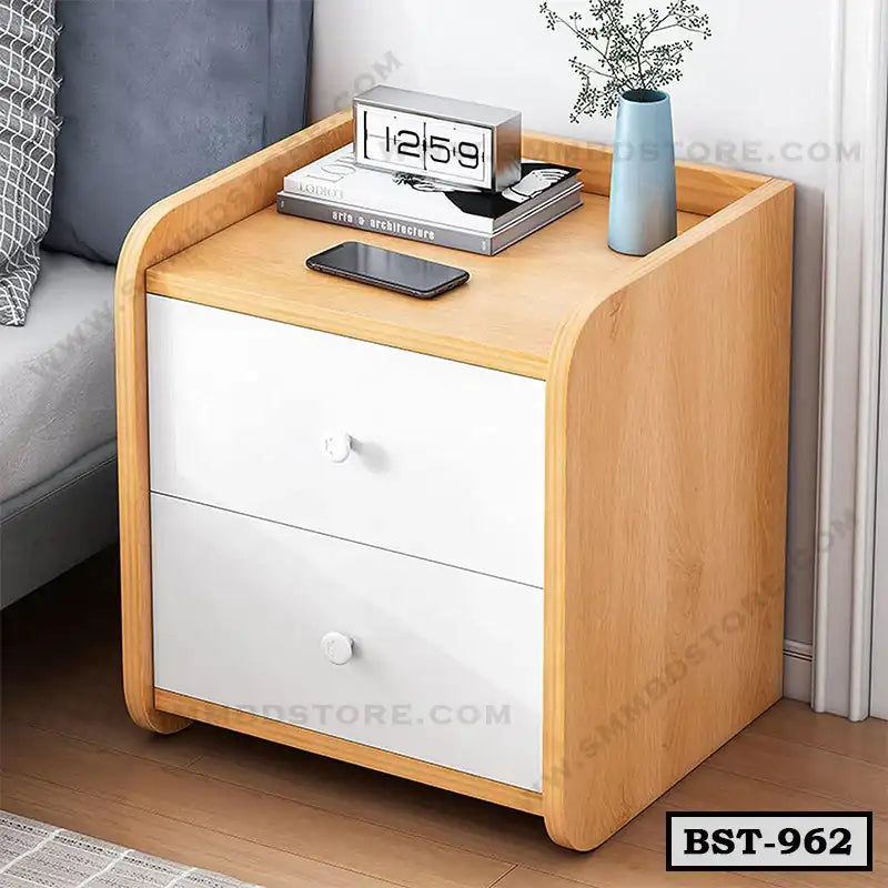 Modern bedside table with two white drawers, wooden frame, clock, books, and vase decor