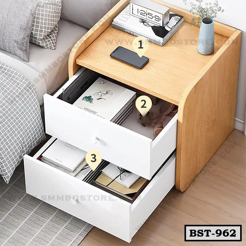 Modern wooden bedside table with two white drawers beside a bed, organized for storage.