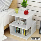 Modern white bedside table with books, a plant, a green cup, and a red alarm clock.