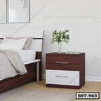 Modern wooden bedside table with two drawers beside a bed in a contemporary bedroom