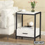 Modern bedside table with drawer, black frame, white finish, next to sofa, home interior