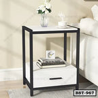 Modern bedside table with black frame, white drawer, and open shelf beside a sofa