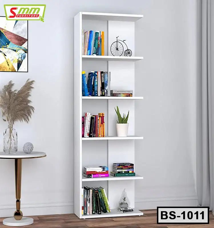 Modern white bookshelf with books, decorative items, and a potted plant in a living room Main image