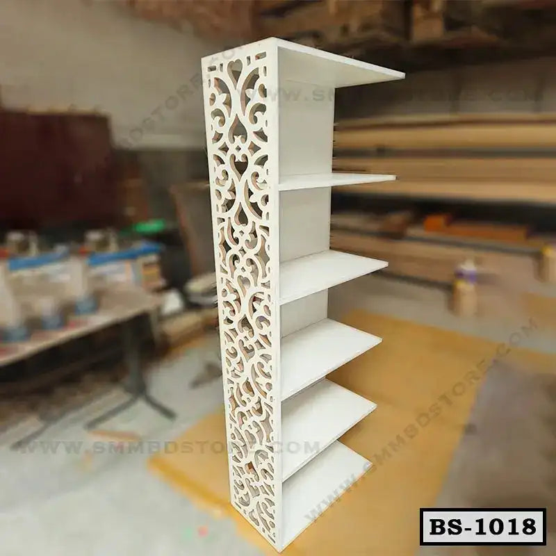 Modern white bookshelf with five shelves and ornate side panel in workshop setting Main image