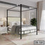 Modern canopy bed frame with padded headboard in a bright bedroom setting