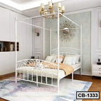 Modern white metal canopy bed frame in elegant bedroom with chandelier and wall decor