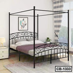 Modern black metal canopy bed frame with elegant scrollwork in a bright bedroom