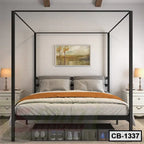 Modern black metal canopy bed frame with pillows and orange blanket in a stylish bedroom