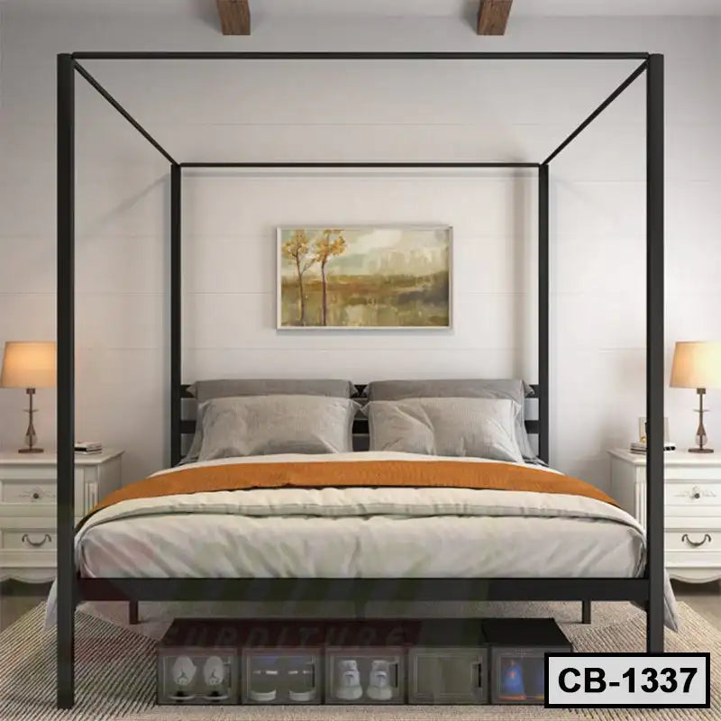 Modern black metal canopy bed frame with pillows and orange blanket in a stylish bedroom