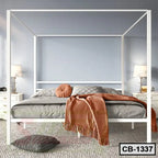 Modern white canopy bed frame with cozy bedding in a stylish bedroom setting