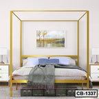 Modern gold metal canopy bed frame in a stylish bedroom with white bedding and nightstands