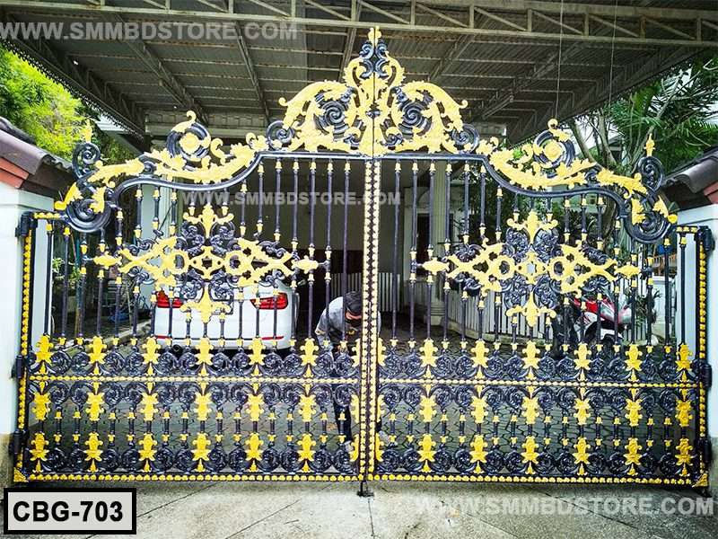 Ornate black and gold metal boundary gate with decorative floral patterns installed outdoors Main image