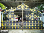 Ornate black and gold metal boundary gate with decorative floral patterns installed outdoors