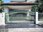 Decorative metal boundary gate with gold accents in front of a modern house