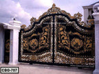 Ornate black and gold wrought iron boundary gate with floral patterns for home entrance