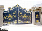 Black and gold decorative metal boundary gate with ornate patterns and columns outdoors