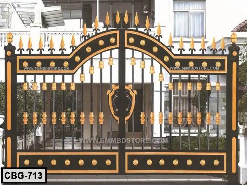 Elegant black and gold boundary gate with decorative spikes and accents, installed at a modern house entrance.