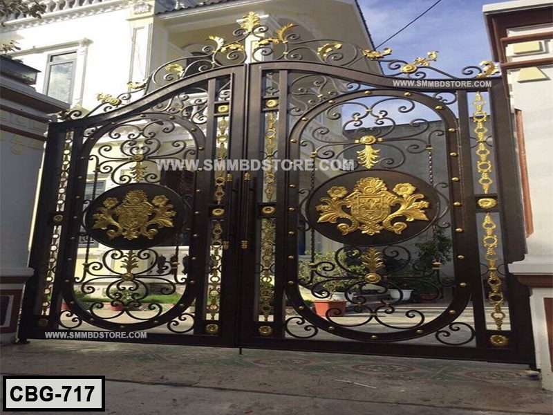 Decorative wrought iron boundary gate with gold floral accents in front of a house.