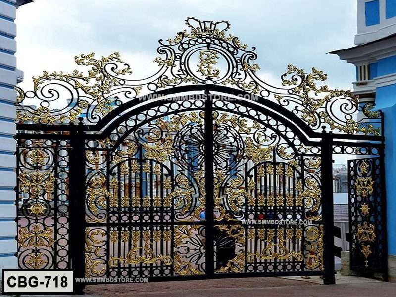 Decorative black and gold wrought iron boundary gate with ornate floral patterns outdoors