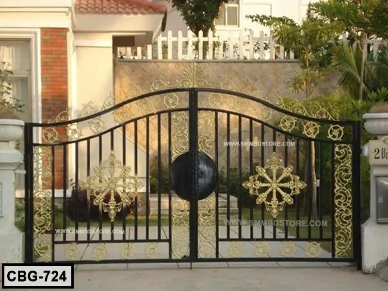 Decorative black and gold boundary gate with ornate floral metalwork in front of a house