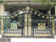 Decorative wrought iron boundary gate with gold floral patterns for home entrance