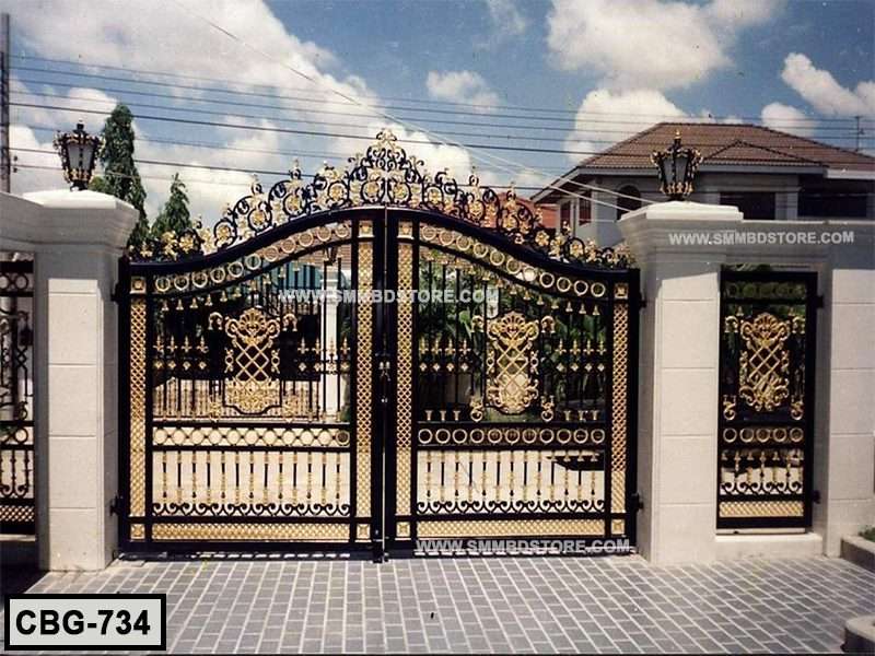 Decorative wrought iron boundary gate with gold accents, set between white pillars outdoors Main image