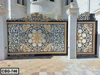 Ornate metal boundary gate with black and gold floral patterns, installed at a modern home entrance