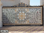 Decorative wrought iron boundary gate with intricate floral designs and gold accents