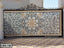 Decorative wrought iron boundary gate with intricate floral designs and gold accents