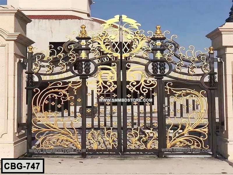 Ornate black and gold metal boundary gate with intricate floral designs, outdoor setting Main image